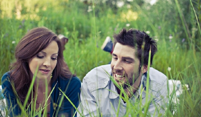 Couple lying in grass
