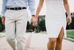 couple in white holding hands