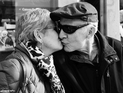 elderly couple kissing