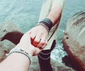 holding hands in the ocean