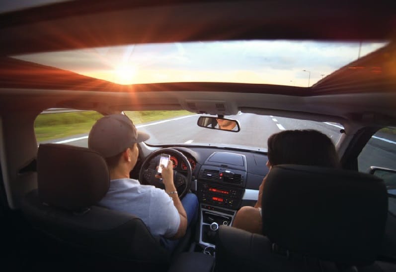 man texting in car