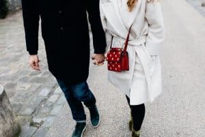 couple holding hands in snow