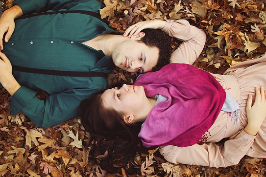 couple lying on leaves