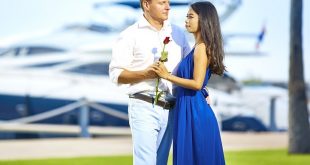 man presenting his woman with flower