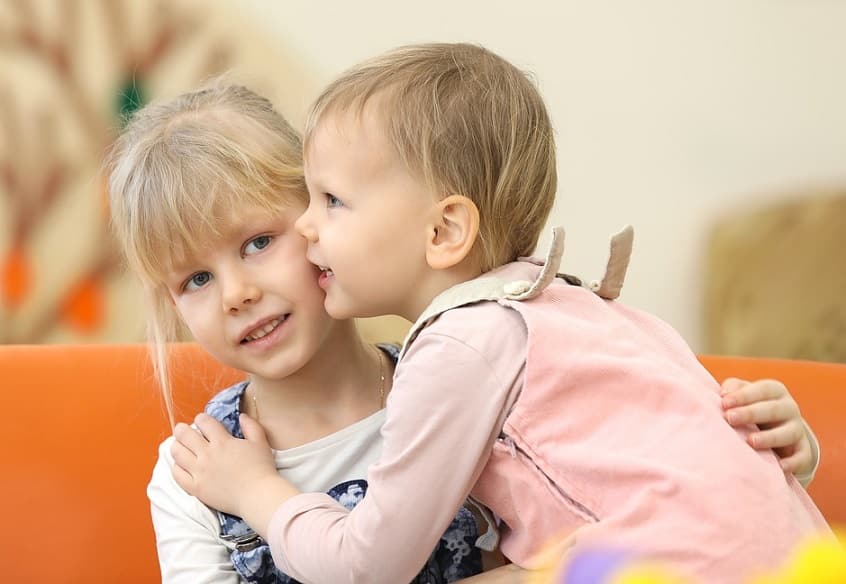 siblings hugging